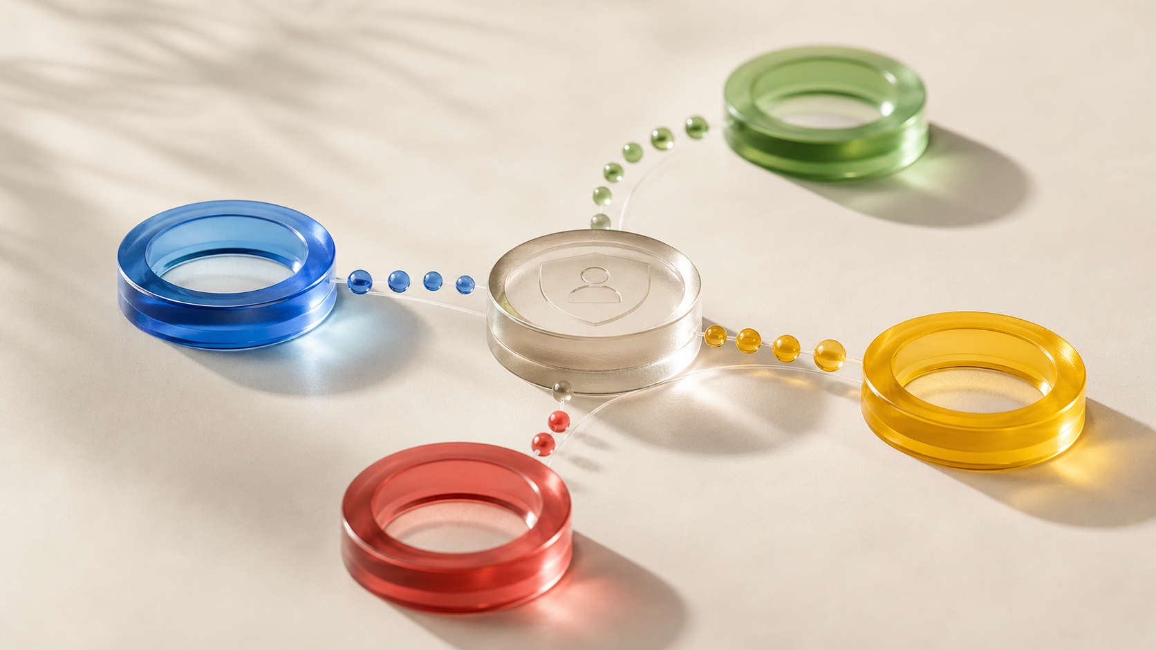 Photographic still life of translucent colored consent-signal rings on a cream surface
